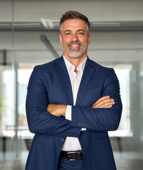 Handsome,hispanic,senior,business,man,with,crossed,arms,smiling,at